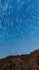 Wall Mural - bright glowing night sky with stars, time lapse vertical view