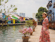 © YURII Seleznov - Young woman in ethnic dress and hat exploring the vibrant streets of Malacca, Malaysia. A blend of cultural heritage, colorful architecture, and tropical charm. Perfect travel and lifestyle moments.