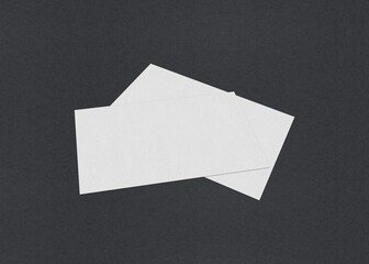 Poster - Two overlapping horizontal rectangular white papers on a dark background, Blank white Business card mockup stacks at grey textured paper background