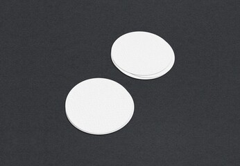 Poster - Two stacks of white circle-shaped papers on a dark surface, Blank white Business card mockup stacks at grey textured paper background