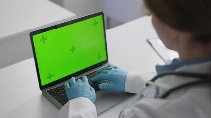 Poster - A medical professional is utilizing a laptop within a clinical environment. This modern equipment enhances care quality and allows for efficient diagnosis and monitoring of patients