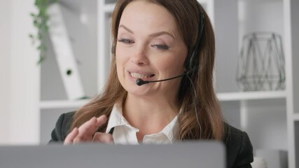 Poster - A highly skilled professional woman actively engaged in virtual communication while using a headset, showcasing her ability to connect and collaborate effectively through modern technology