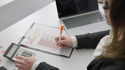 Poster - A skilled professional analyzes financial data with a calculator and laptop, reviewing reports and statistics to make informed finance and investment decisions for company growth and strategy