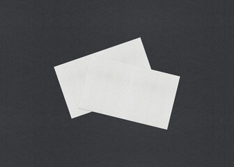 Poster - Two overlapping white rectangular papers on a dark background, Blank white Business card mockup stacks at grey textured paper background