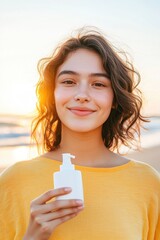 Wall Mural - Smiling woman holding a skincare product on a beach during golden hour, radiating beauty and wellness in a vibrant summer setting