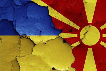 Wall Mural - Flags of Ukraine and North Macedonia painted on cracked wall