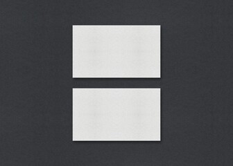 Poster - Two white rectangular sheets vertically aligned on a gray background, Blank white Business card mockup stacks at grey textured paper background