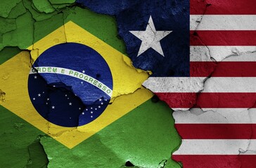 Wall Mural - Flags of Brazil and Liberia painted on cracked wall