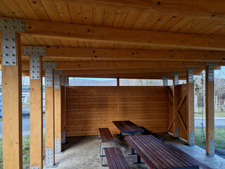 terrace with wooden pergola and plexiglass roof. vines are straining, crawling under the beams. garden or park. sitting with dry wall wine region. restaurant countryside france, truss