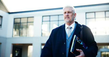 Fototapete - Mature man, teacher and walking at school with books for lesson, start teaching and education commute. Male lecturer, travel and journey for learning, legal studies and academy knowledge with wisdom