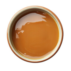 Aufkleber - A top-down view shows a small bowl filled with a glossy, amber-colored caramel sauce.
