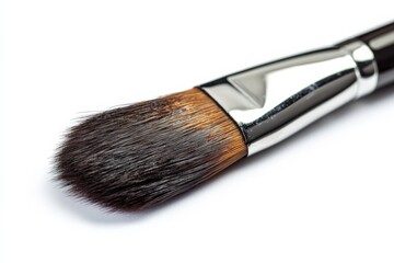 Poster - Detailed close-up of a professional makeup brush resting on a clean surface showcasing its bristles and sleek design