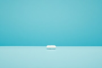 Aufkleber - Pill placed on a blue tabletop against a solid blue backdrop captures attention and highlights the simplicity of its design