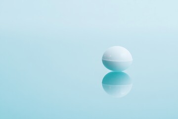 Aufkleber - Floating white sphere on calm blue surface reflecting light in serene environment