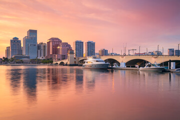 Wall Mural - West Palm Beach, Florida, USA. Cityscape image of West Palm Beach, Florida with reflection of the city skyline in the water at beautiful sunset.