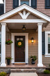 © MatandSterre - Elegant Home Exterior: Classic Porch Design with Modern Touches.  Beautiful front door, landscaping, and architectural details create a welcoming entrance.
