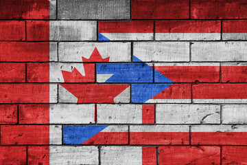 Wall Mural - colourful painted big flag of canada and flag of puerto rico on a massive old brick wall background. concept