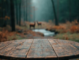 Poster - Rustic wooden table by forest stream with blurred deer in background, misty morning light