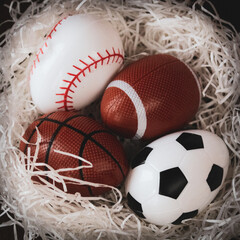 abstract nest with sports themed Easter eggs spring backdrop graphic element eggs soccer football baseball basketball on white grass close-up