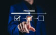 © Supatman - Progress Tracking and Task Management Concept. A person interacting with progress bar and checklist symbolizes task management, project development, and workflow efficiency in business operations.