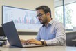 © Ryzhkov - Minimalist Data Insight Hub Young South Asian Entrepreneur with Laptop and Whiteboard Graphs - Innovative Business Strategy and Digital Marketing Enhancement