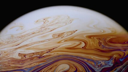 Wall Mural - Closeup video of a soap bubble showing thin film interference concept and the resulting different colors of light with each moving and swirling shapes. Perfect for illustrating concepts of physics.