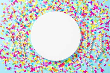 Poster - White circular space surrounded by colorful confetti and striped candles on a light blue background.