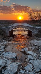 Poster - Sunset paints the sky in vibrant hues, illuminating a dilapidated bridge alone over a parched riverbed. Nature reclaims its space, whispering stories of forgotten journeys