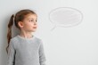 © EvaMur - A girl in a gray sweatshirt looks away, a speech bubble is drawn in pencil, a banner, a copy space.