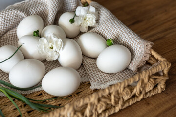 Wall Mural - Handcrafted basket with white eggs ready for Easter celebrations in spring season