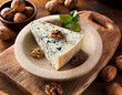 © Arda ALTAY - A slice of blue cheese garnished with fresh mint and walnuts is served on a cream-colored plate atop a wooden cutting board with scattered nuts in the background.