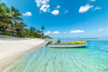 Wall Mural - Boat moored in an empty tropical beach on a sunny day