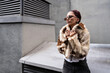 © ADDICTIVE STOCK - Urban fashion statement with faux fur and sunglasses