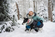 © ADDICTIVE STOCK - Child and dog enjoying snowy forest day