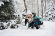 © ADDICTIVE STOCK - Joyful winter day with child and dog in snowy forest