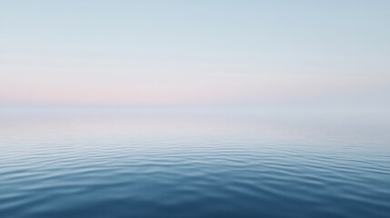 Wall Mural - Calm blue sea reflecting pastel colored sky at dawn