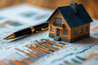 © shamek - Real estate sales realtor on the graph is a small house layout and a pen