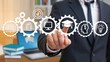 © Media Srock - Education, knowledge and innovation concept. Businessman touching virtual gears with education icons.