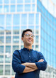 © insta_photos - Happy young Hispanic business man entrepreneur looking away, confident businessman leader investor standing arms crossed on city street thinking of future leadership and success. Vertical portrait.
