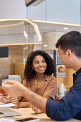 Aufkleber - Busy happy diverse professional employees using laptop discussing project. Business team two man and woman talking working together. African American bank manager consulting client at office meeting.