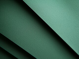 Poster - Abstract background featuring overlapping sheets of textured green paper, creating a dynamic composition of diagonal lines and shadows, suitable for design projects