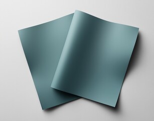 Poster - two empty turquoise sheets of paper are curled upwards on a white background, creating an elegant an
