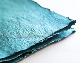 Poster - Close-up of beautiful textured cyan handmade paper with deckled edges, highlighting the craftsmanship and adding an artistic touch to stationery or invitations