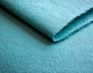 Poster - Close-up of folded light turquoise fabric showcasing its texture and a frayed edge, creating an abstract composition with potential use in textile, fashion, or design projects