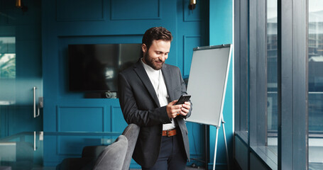 Poster - Typing, businessman and smile with smartphone in office, reading story and online source for publication. Career, male person and journalist with mobile for creative agency, digital blog and scroll