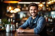 © ThomasLENNE - portrait of a young smiling Romanian male bartender against blurred bar background