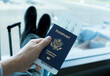 © kieferpix - Man sitting at airport holding USA passport waiting for flight
