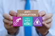 © wladimir1804 - Business person holding colorful blocks with icons sees inscription: ANTI-CORRUPTION. Concept of anti corruption activities that oppose or inhibit corruption. International anti-corruption day.