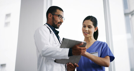 Poster - Healthcare, doctor and nurse with tablet in hospital for medical planning, surgery results or discussion. Low angle, medicine team or happy with digital app for health information or diagnosis result