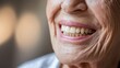 © Tom - Close-up of an elderly woman's smiling face, showcasing her bright, healthy teeth and joyful expression that radiates warmth.